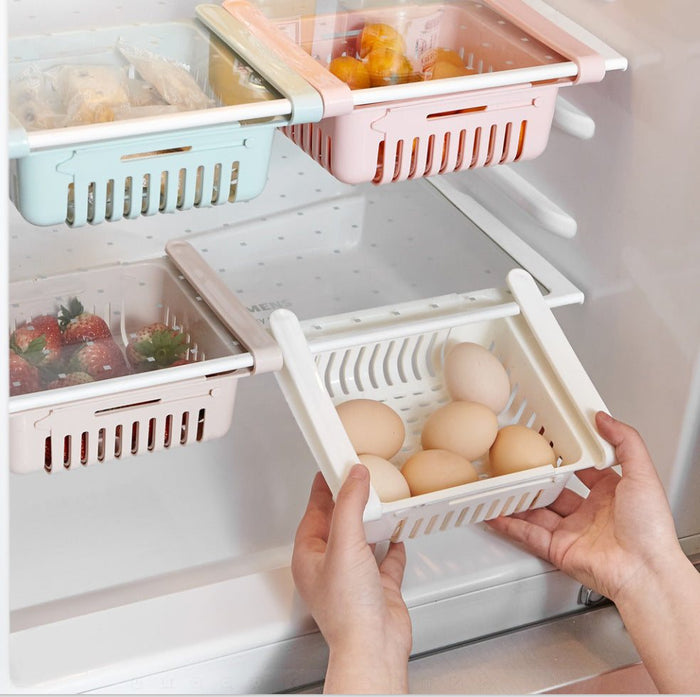 Stretchable refrigerator storage basket organizing canned drinks and vegetables inside fridge