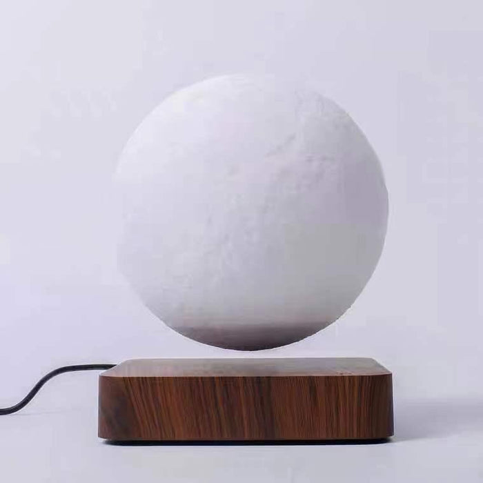 Magnetic levitation table lamp with 3D printed moon night light suspended above wooden base