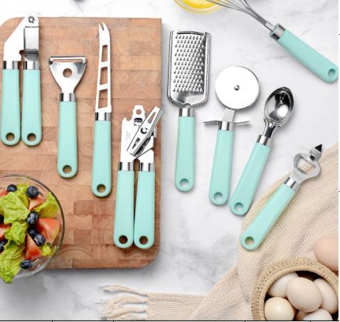 Set of modern kitchen utensils with plastic handles and stainless steel heads in various colors including green, black, red, and black-green combination